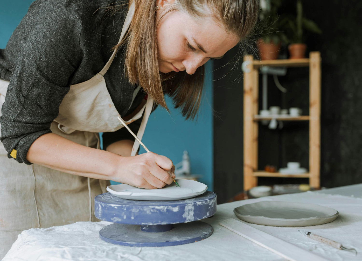 a student makes a handmade mug during class